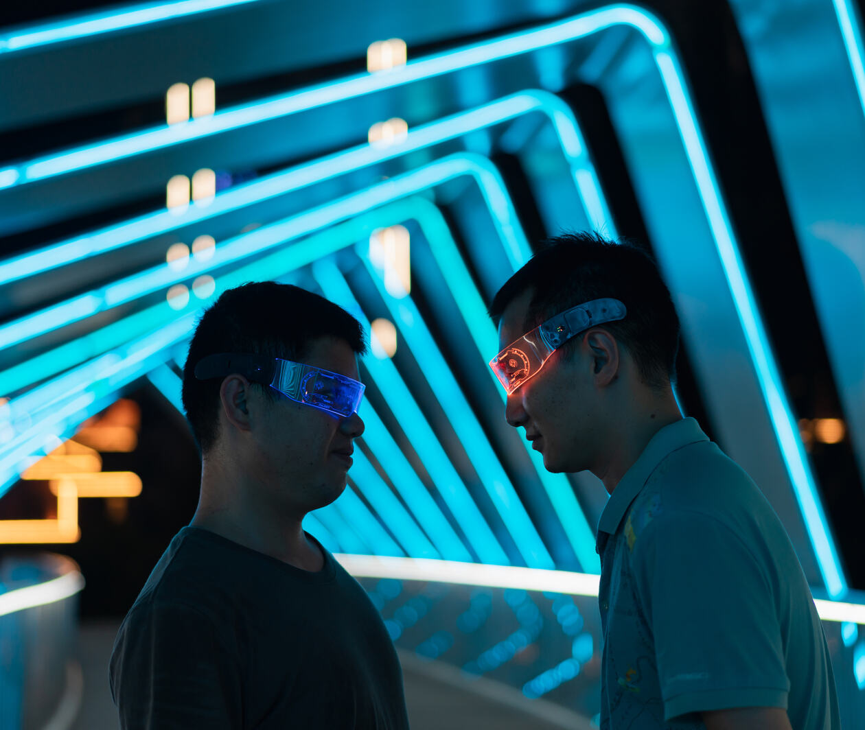 Two men facing each other wearing virtual reality glasses.