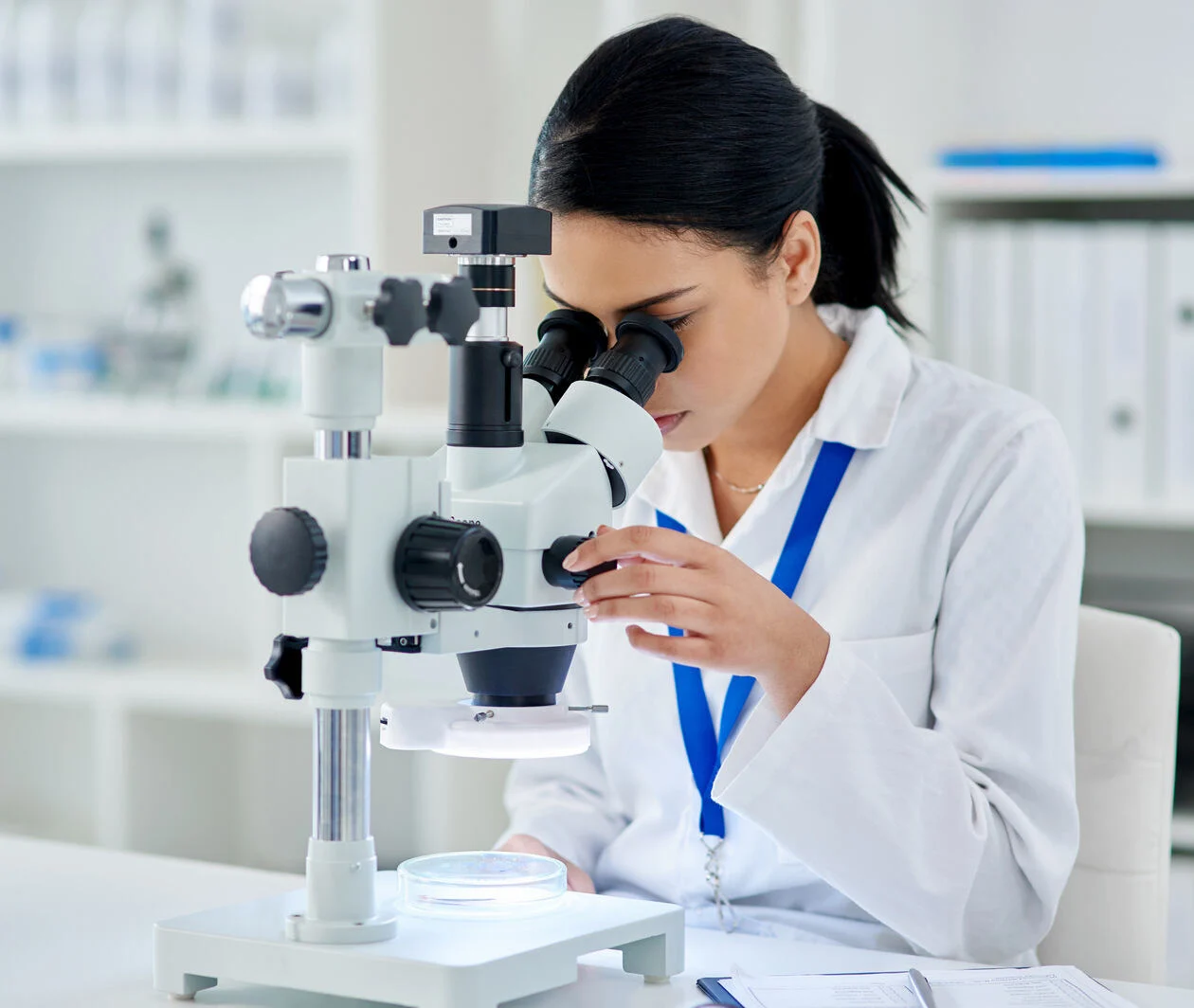 Shot of a young scientist using a microscope in a laboratory.