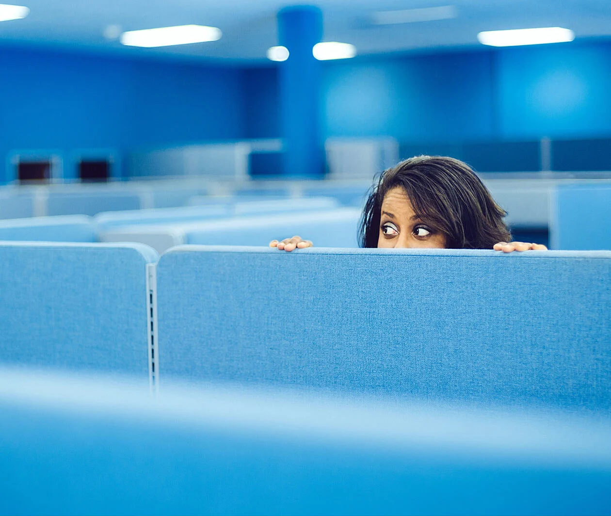 Office worker eavesdropping in cubicle room