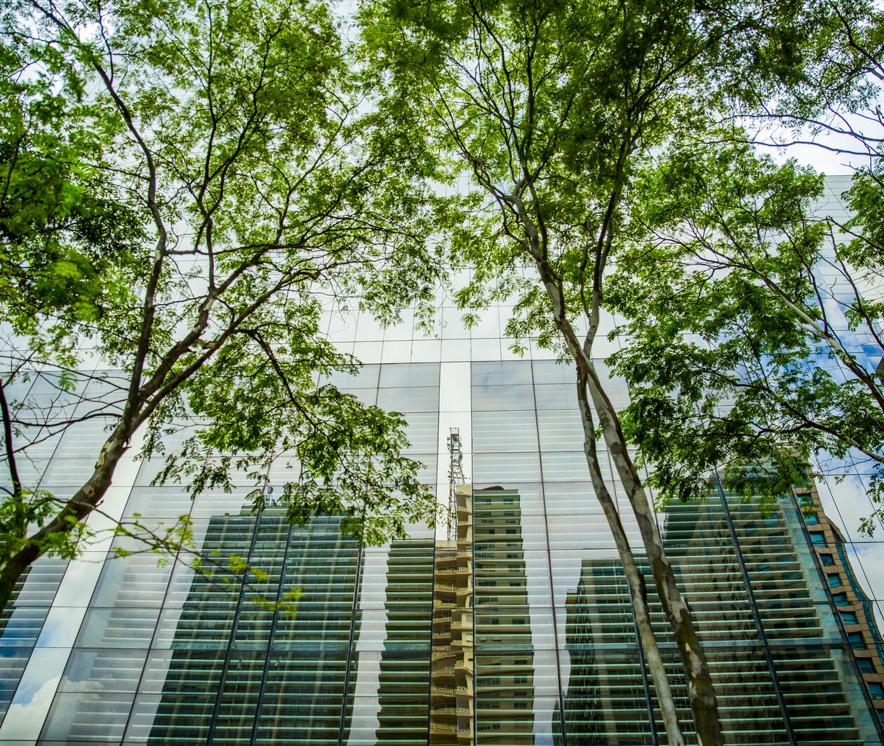 Buildings reflected in the Paulistano building. Streets of downtown São Paulo, Brazil.