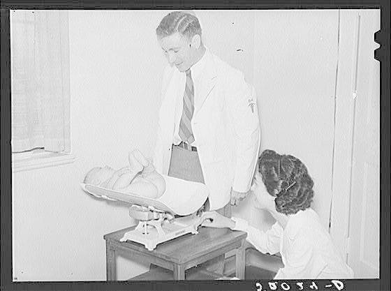 Image of weighing a baby at a medical centre.