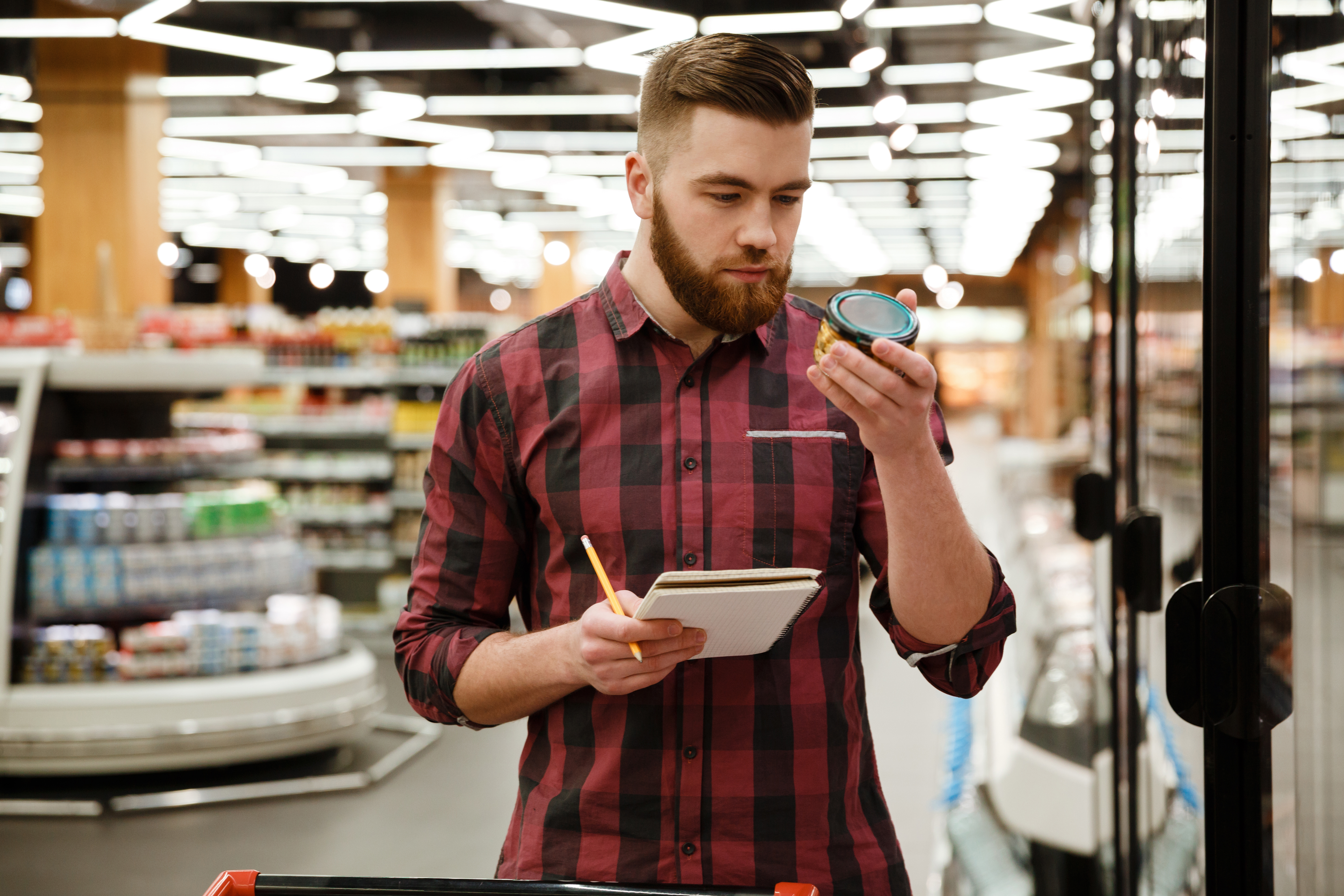 Individual reading a label on a jar