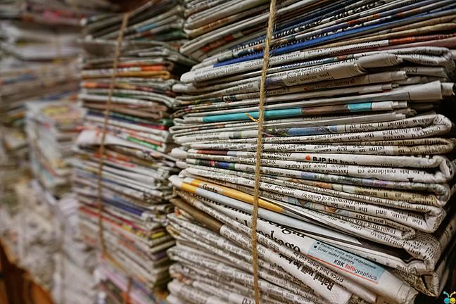 A photograph of a stack of newspapers