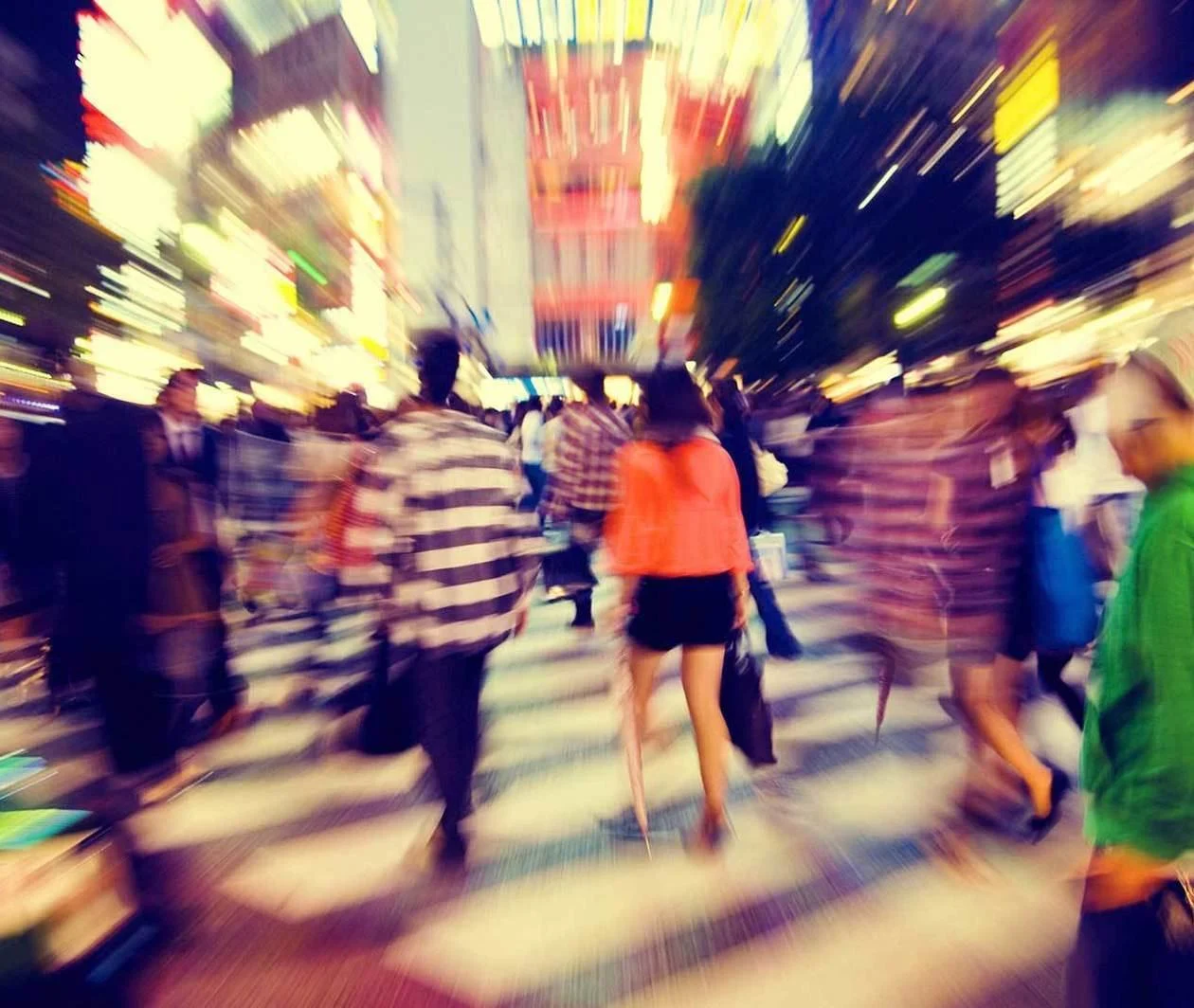 People navigating a busy street crossing