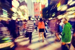 People navigating a busy street crossing