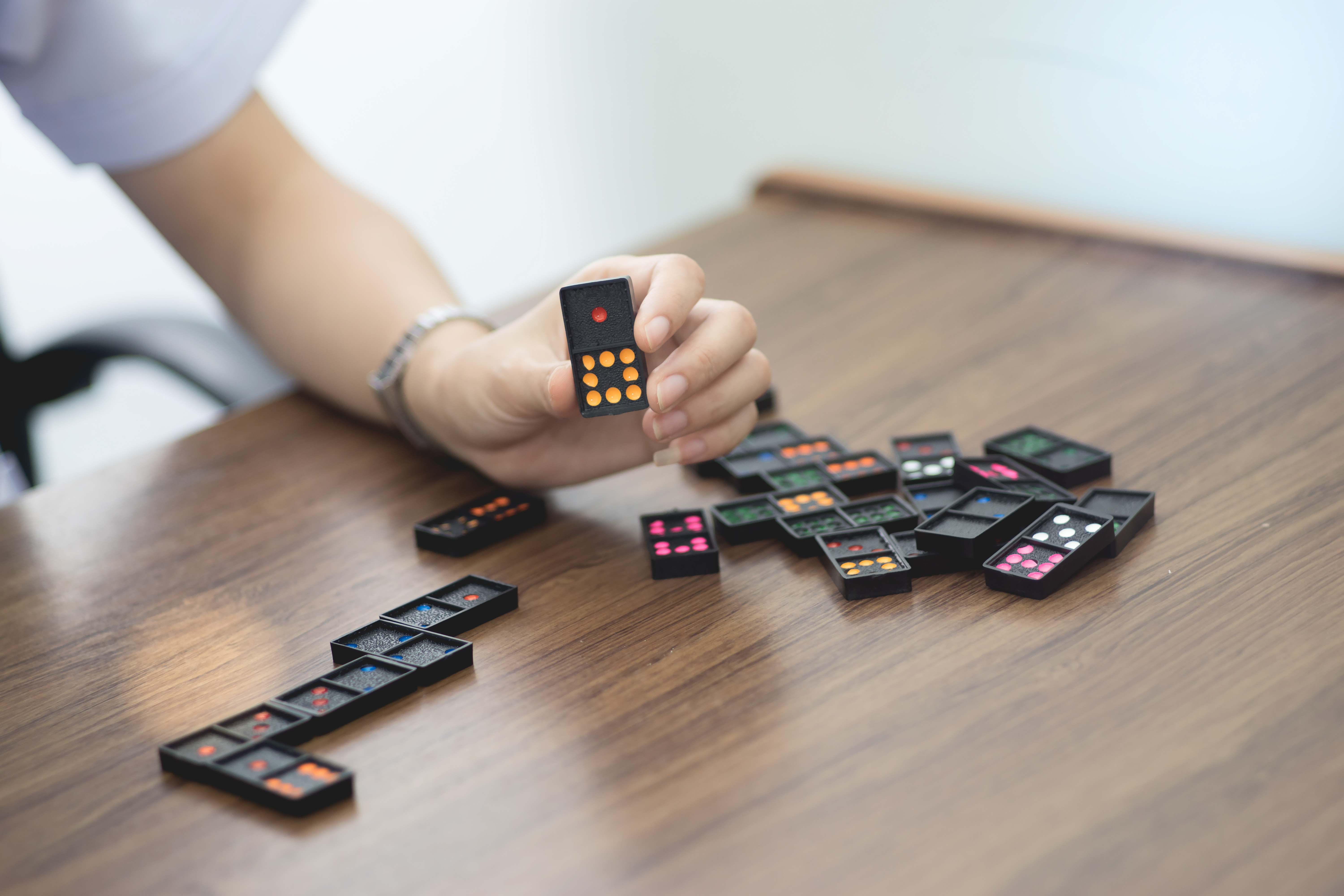 Picture of a person playing with dominoes