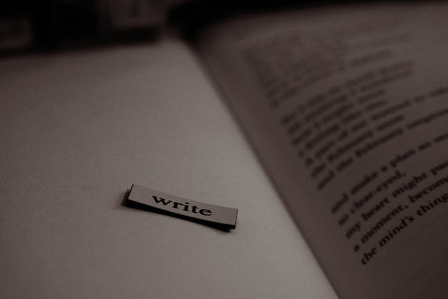 An open book with the word 'write' on a separate page.