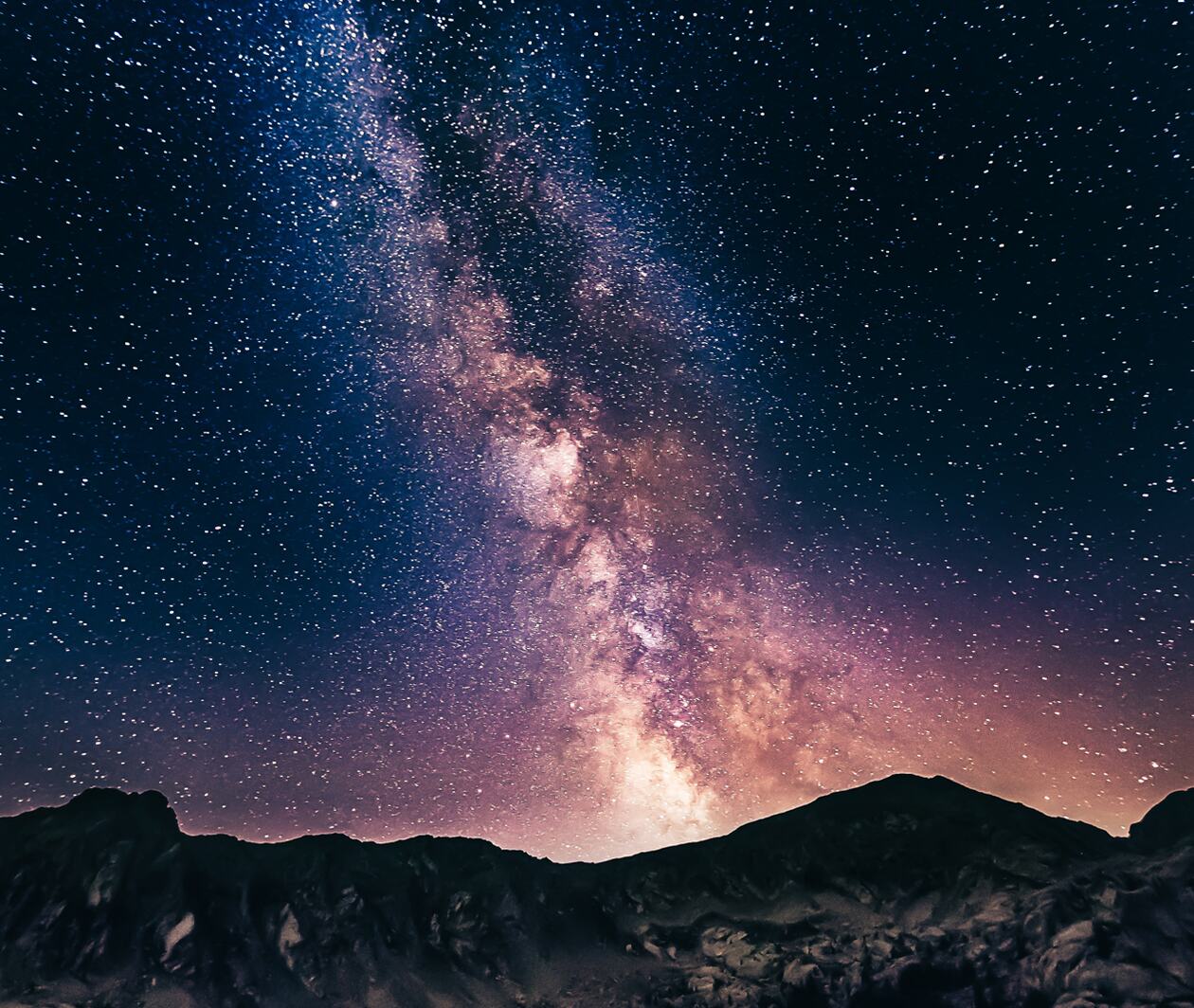 A starry night sky above a mountain range