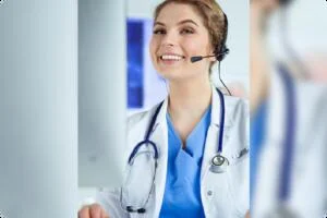 A veterinarian with a stethoscope around her neck, smiles while looking up