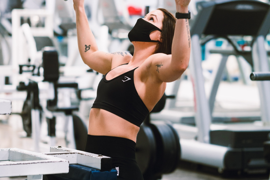 lady doing Lat pull down with mask