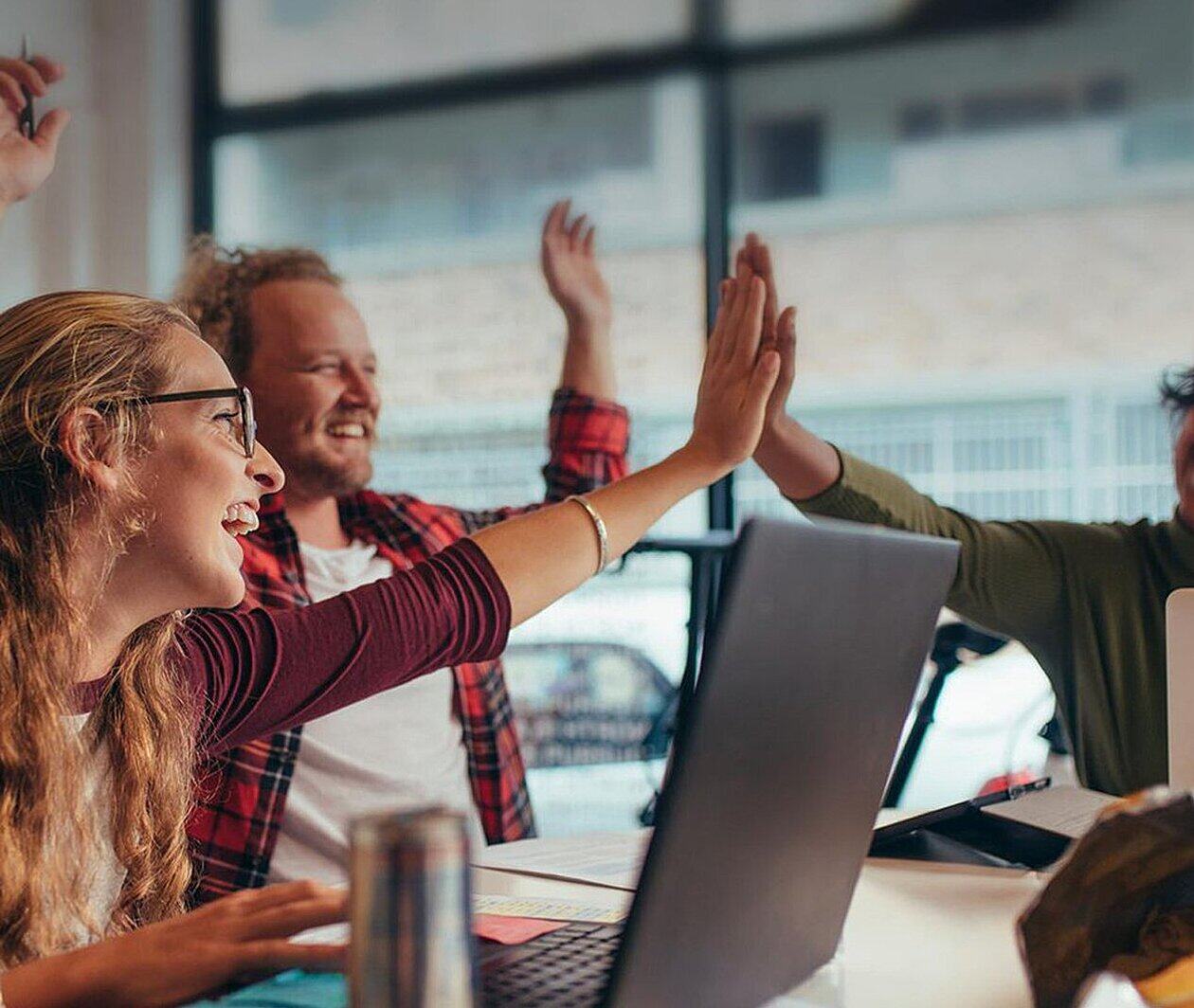 Hackathon team-members high-fiving