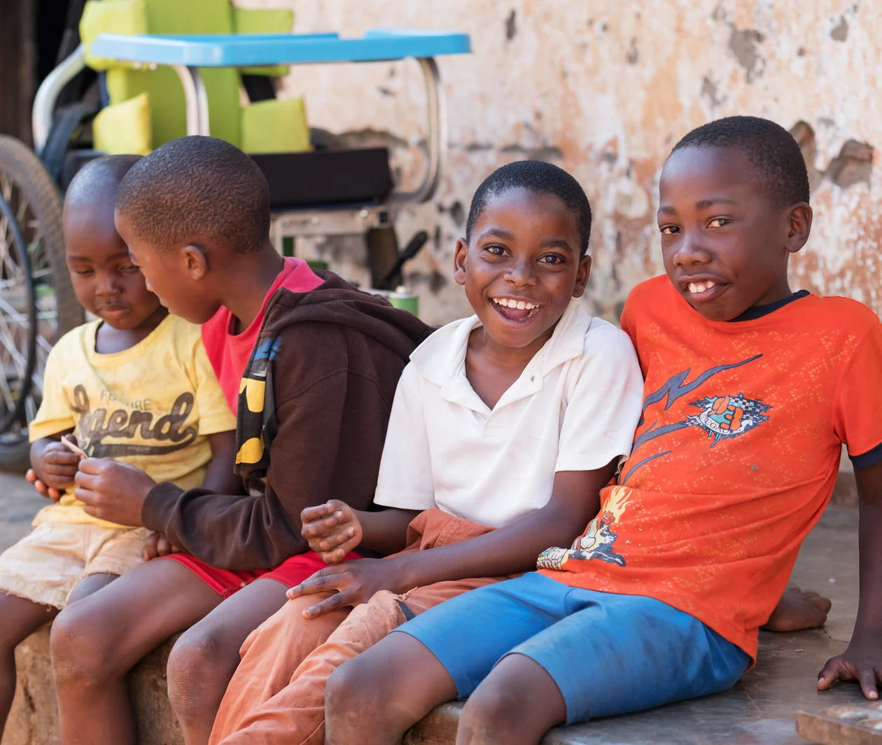 Young boy with cerebral palsy from Malawi smiling at the camera