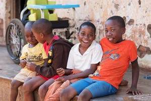 Young boy with cerebral palsy from Malawi smiling at the camera