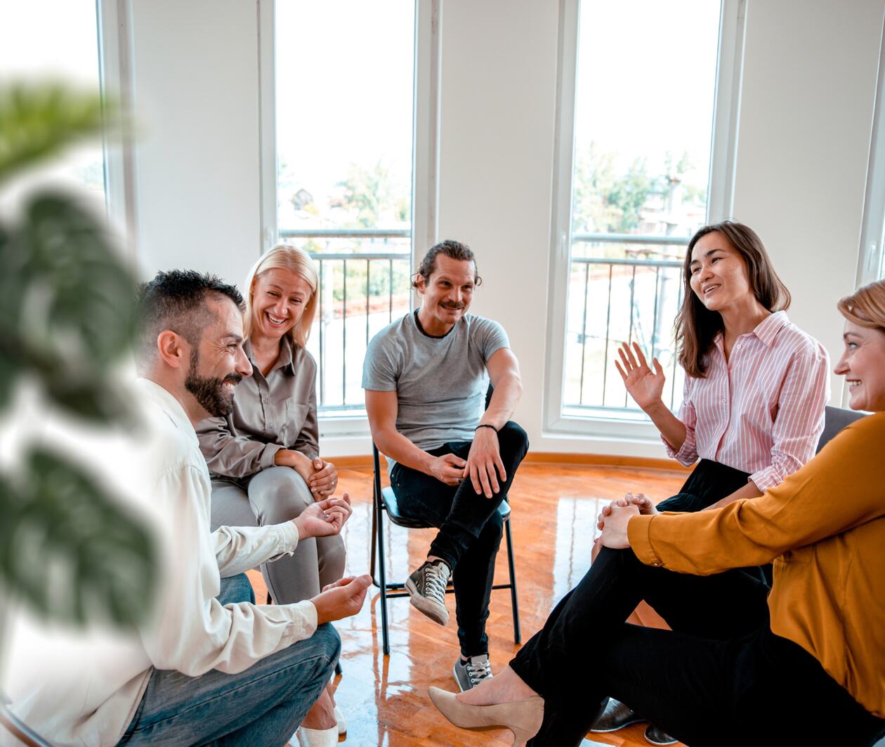 A group of people chatting on chairs