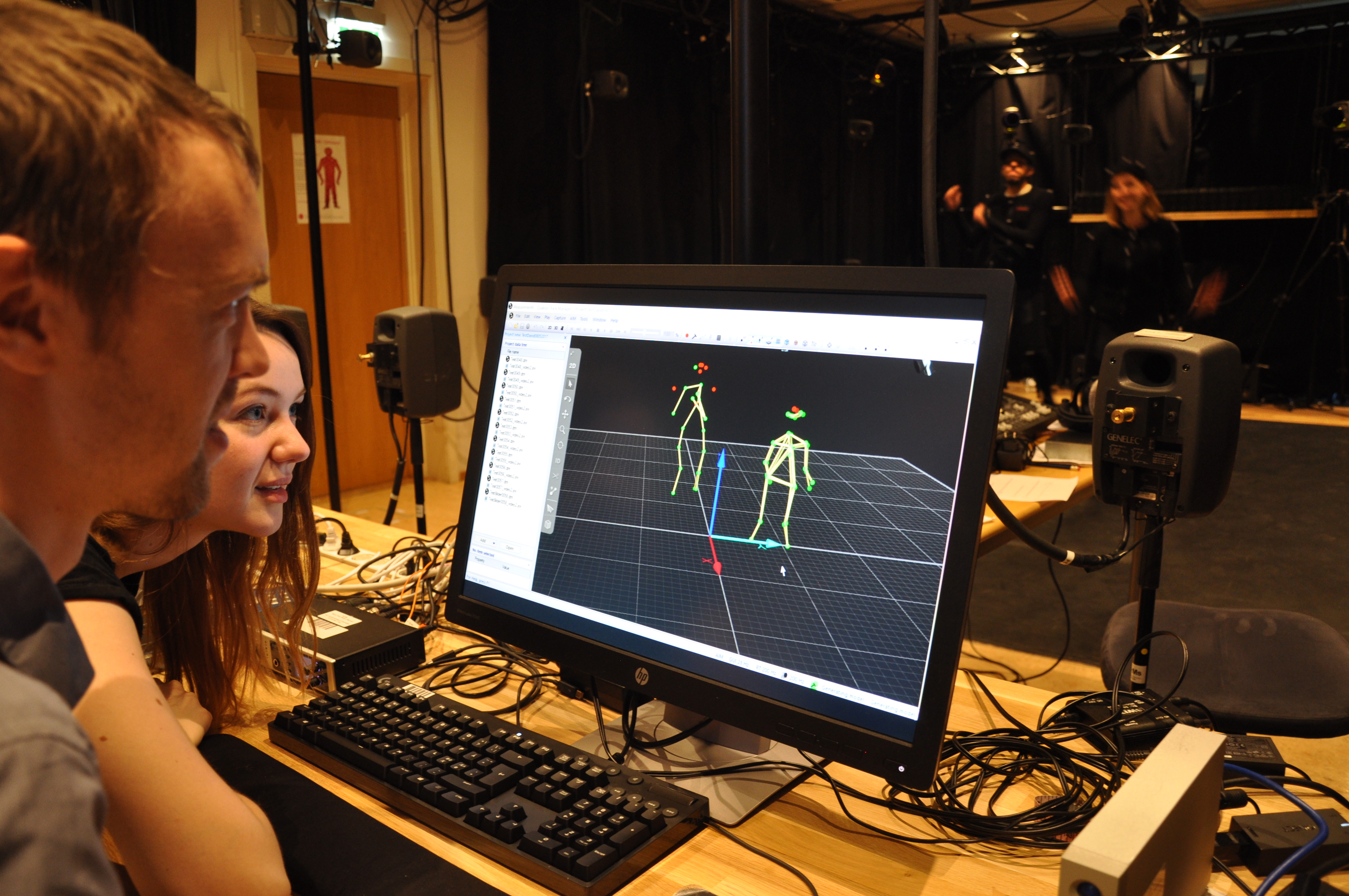 People in mocap lab. A motion capture experiment is underway.