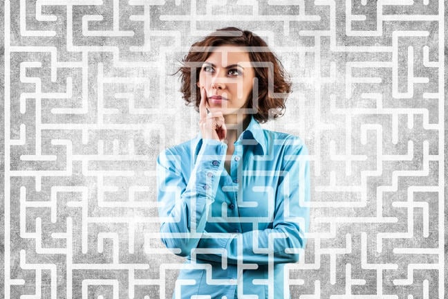 A woman thinking surrounded by a maze