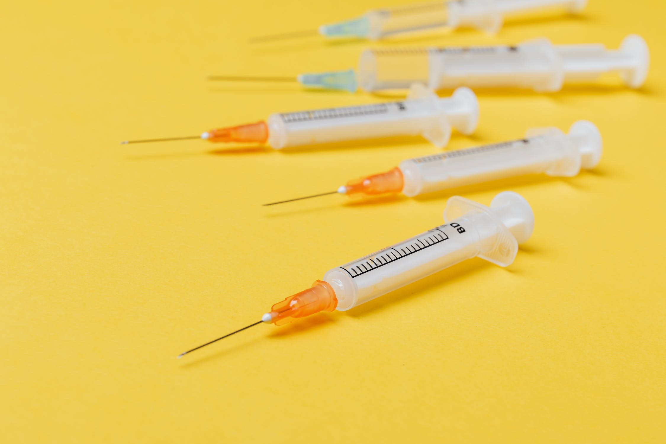 Collection of needles on yellow surface