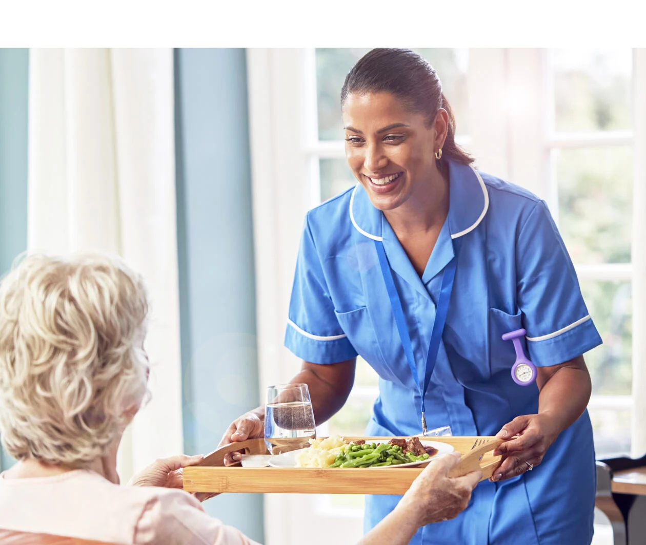 young caregiver caring a senior female wheelchair-bound patient