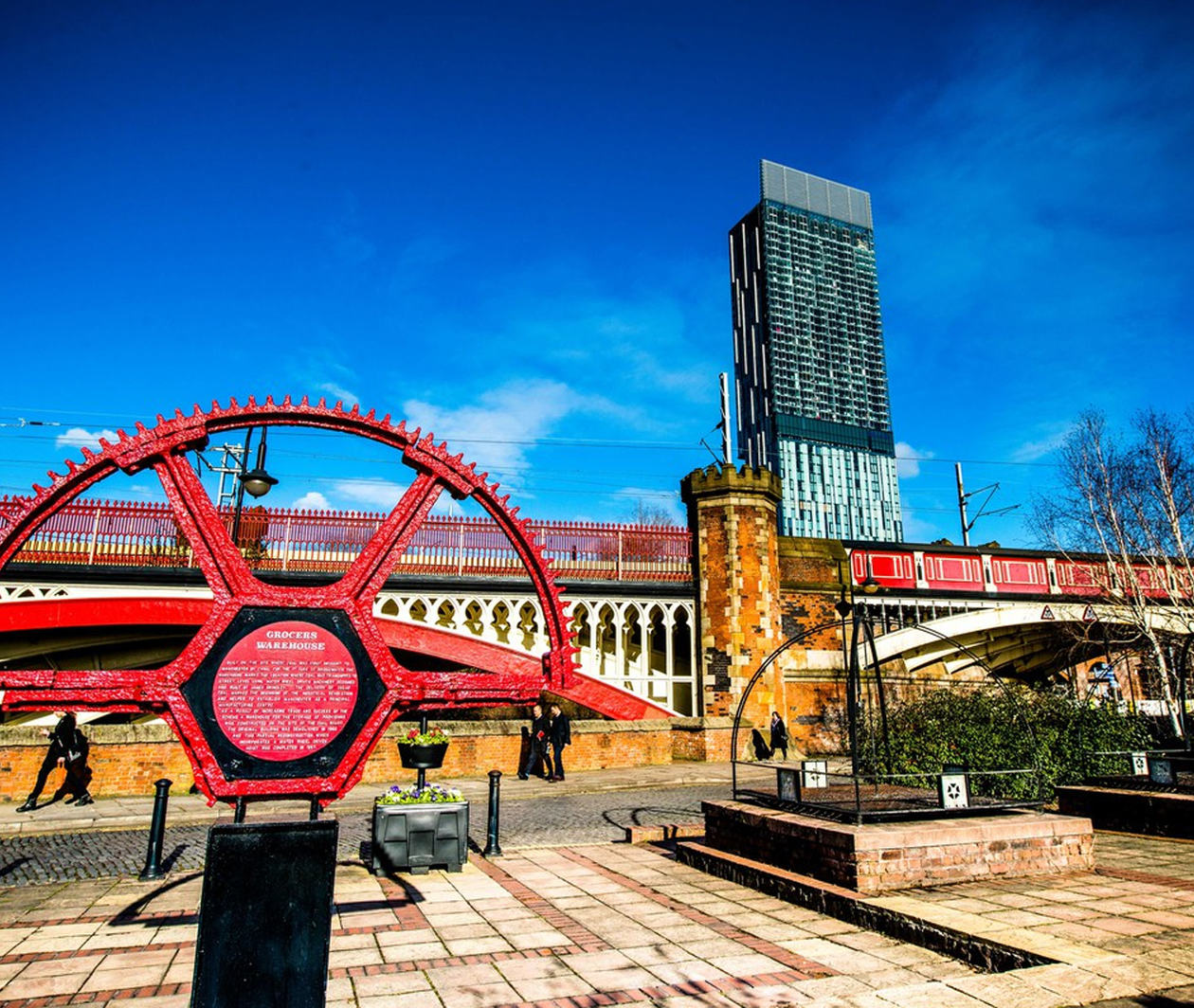 Industrial wheel sculpture set against modern office building