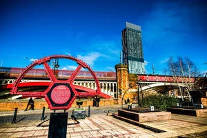 Industrial wheel sculpture set against modern office building