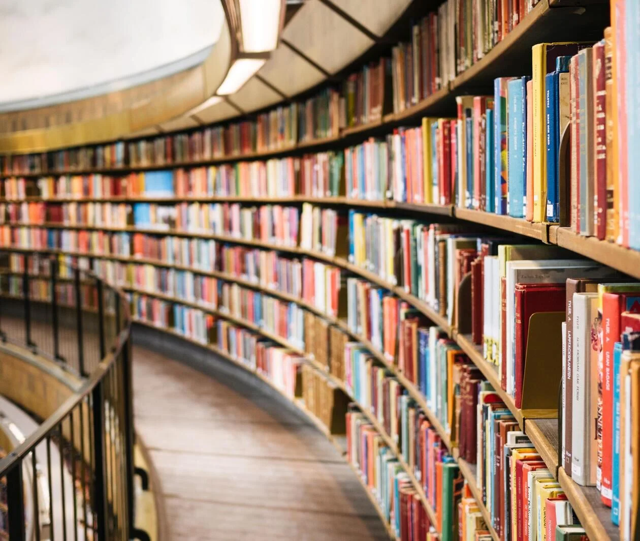 a photo of a large library shelf, containing books on a wide range of topics