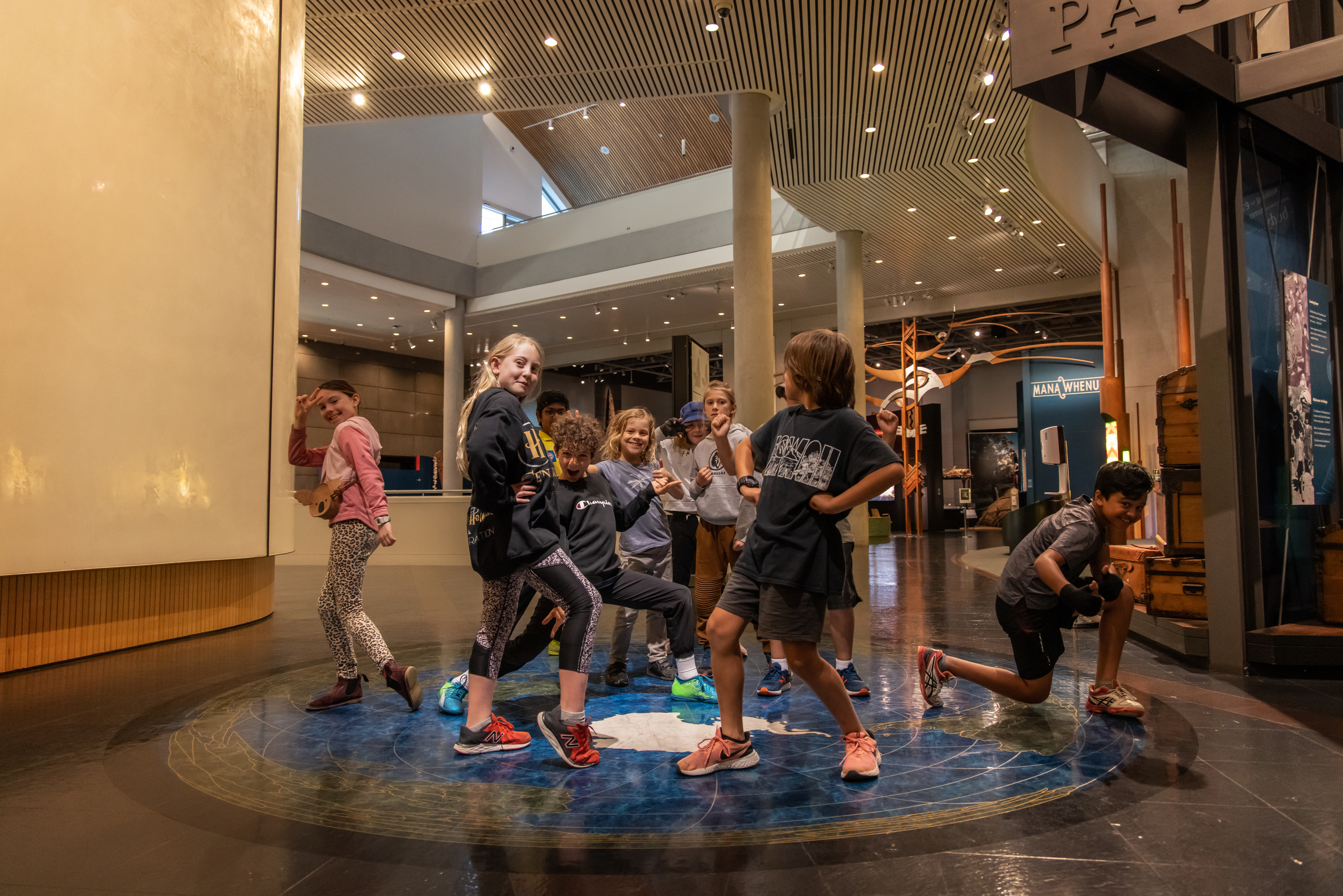 Students dancing, moving and striking poses in Te Papa museum