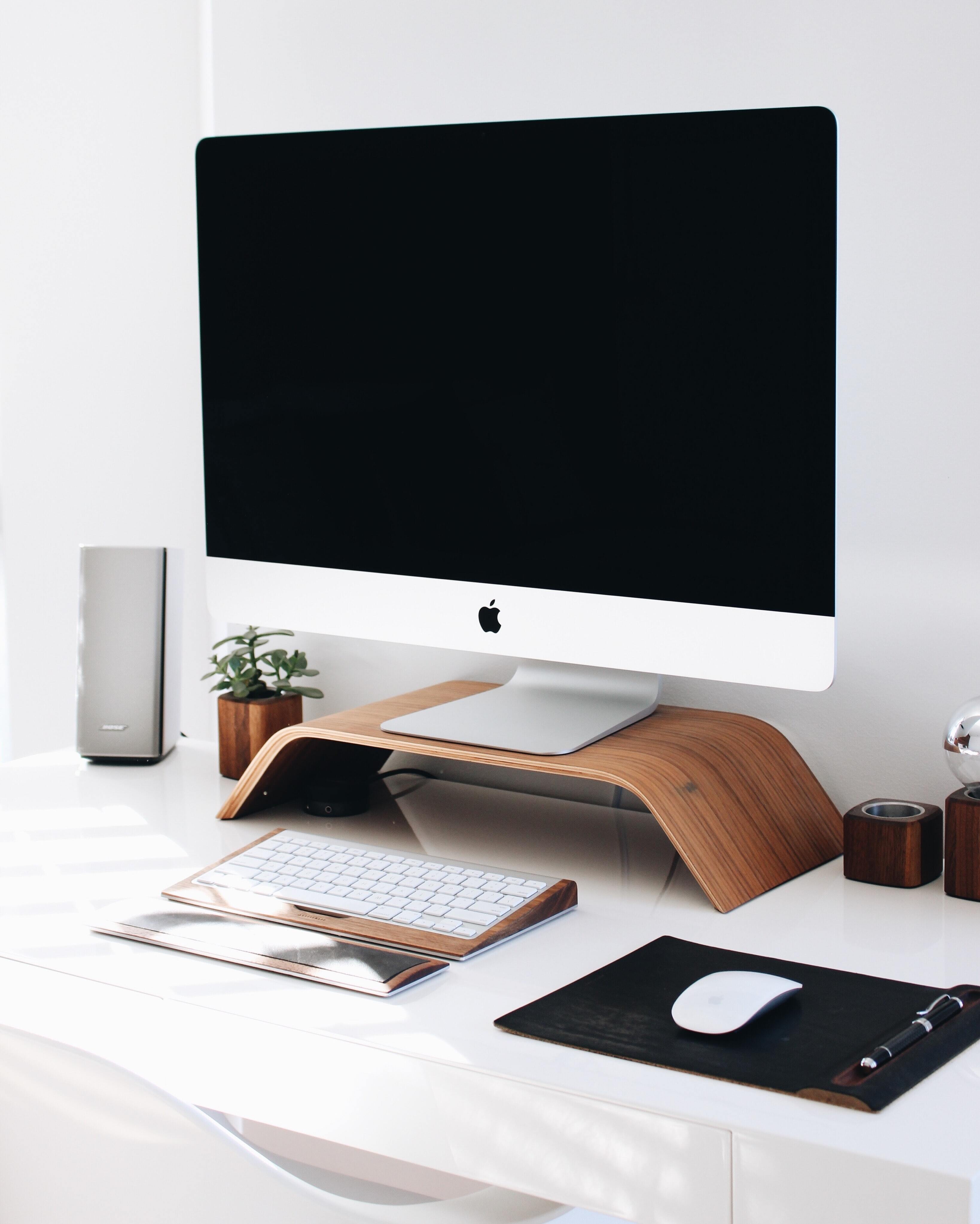 White IMac on white desk.