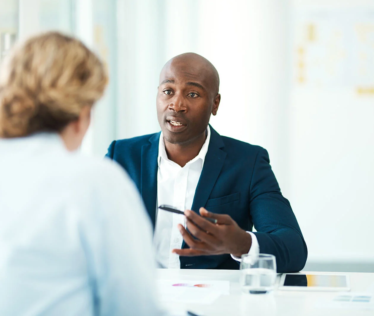 A professional business man talking with his client on a desk with confident