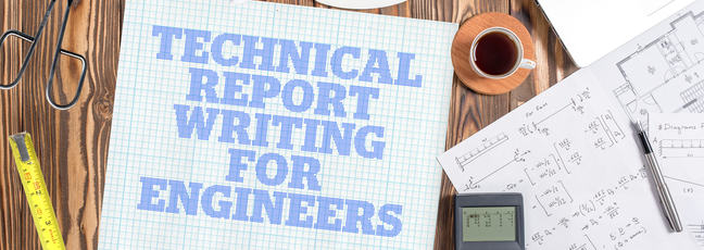 A top-down view of an engineer's desk with laptop, safety helmet, calculator, ruler, and handwritten calculations. In the centre is a sheet of grid paper with the words Technical Report Writing for Engineers printed. 