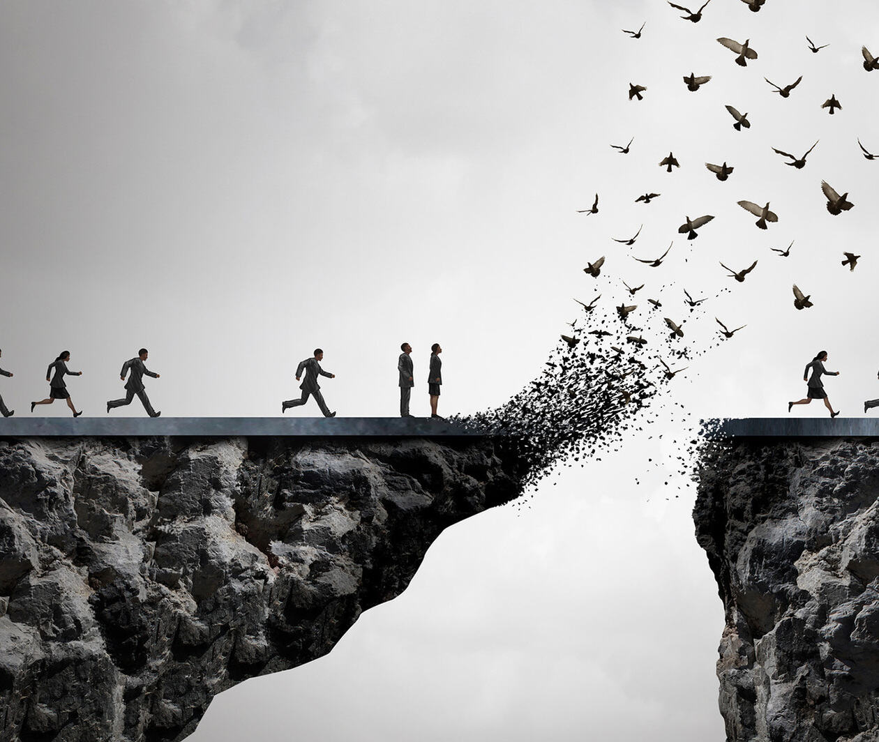 two people standing on opposites side of a bridge which is disintegrating  