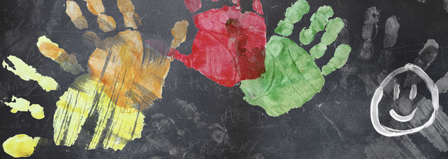 School blackboard with colourful handprints