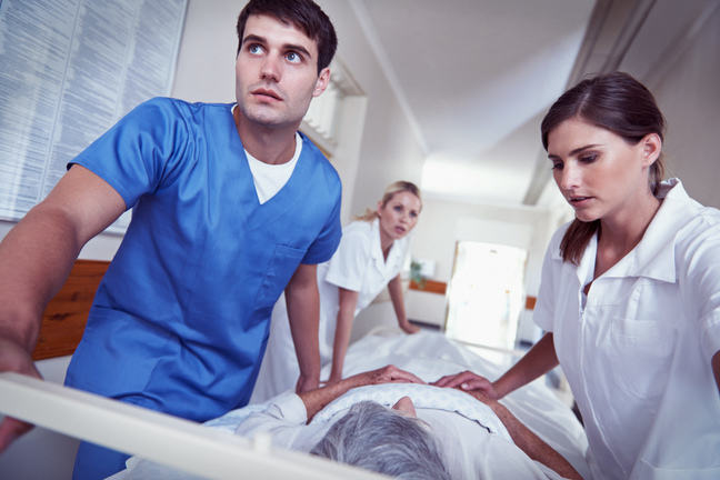 A team of nurses transporting a patient through hospital.