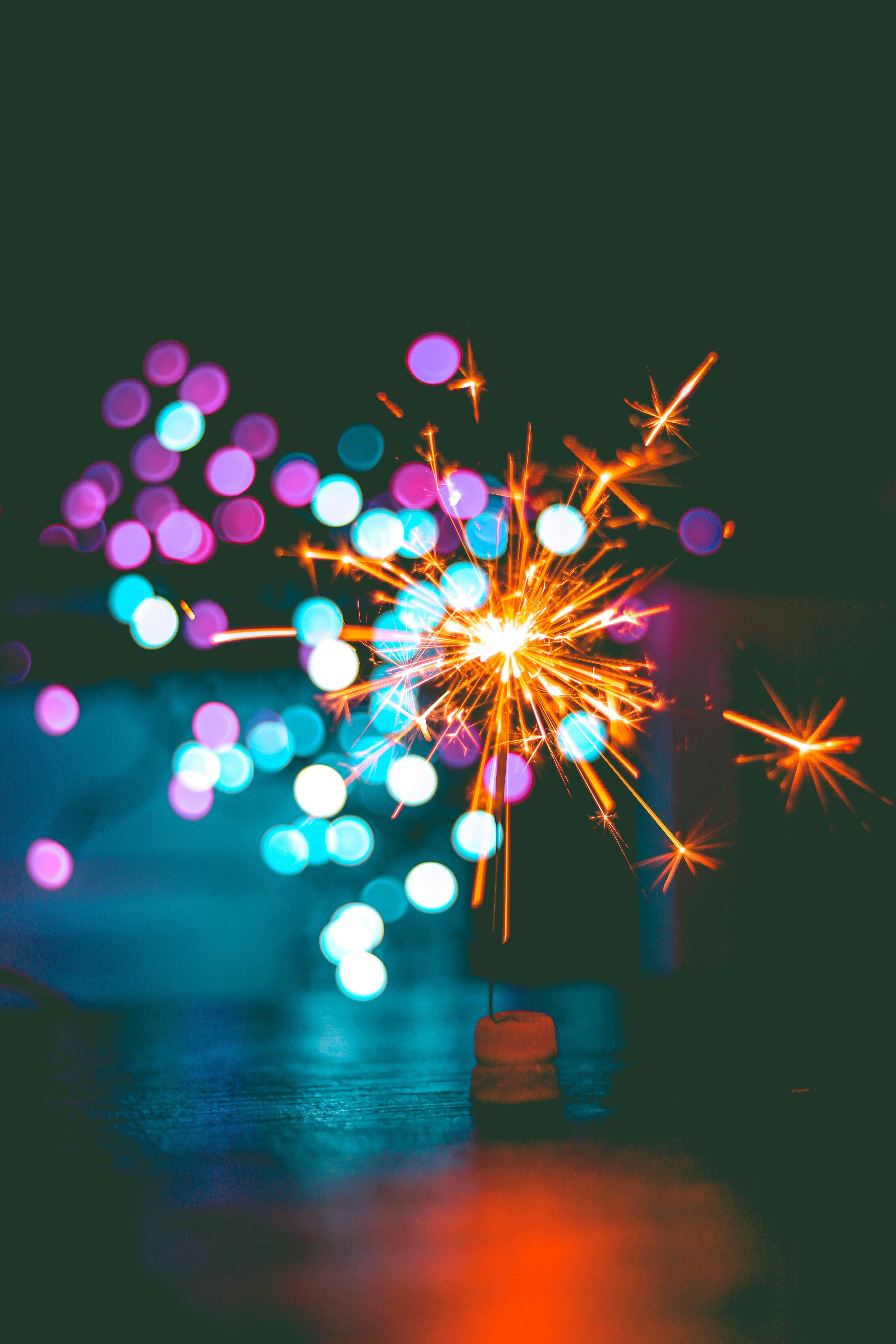 Sparklers burning against a dark background