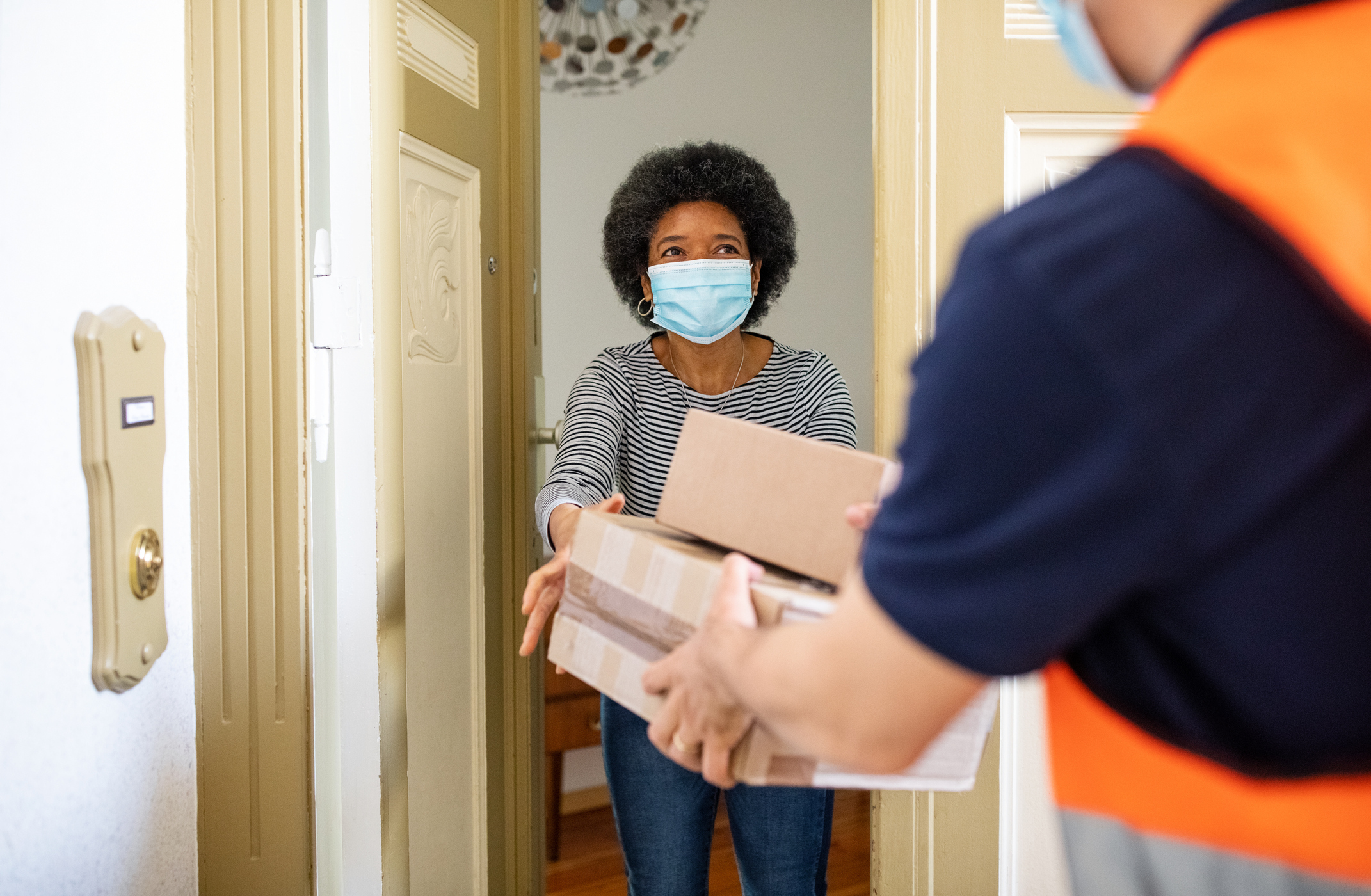 A person receiving a delivery of parcels.