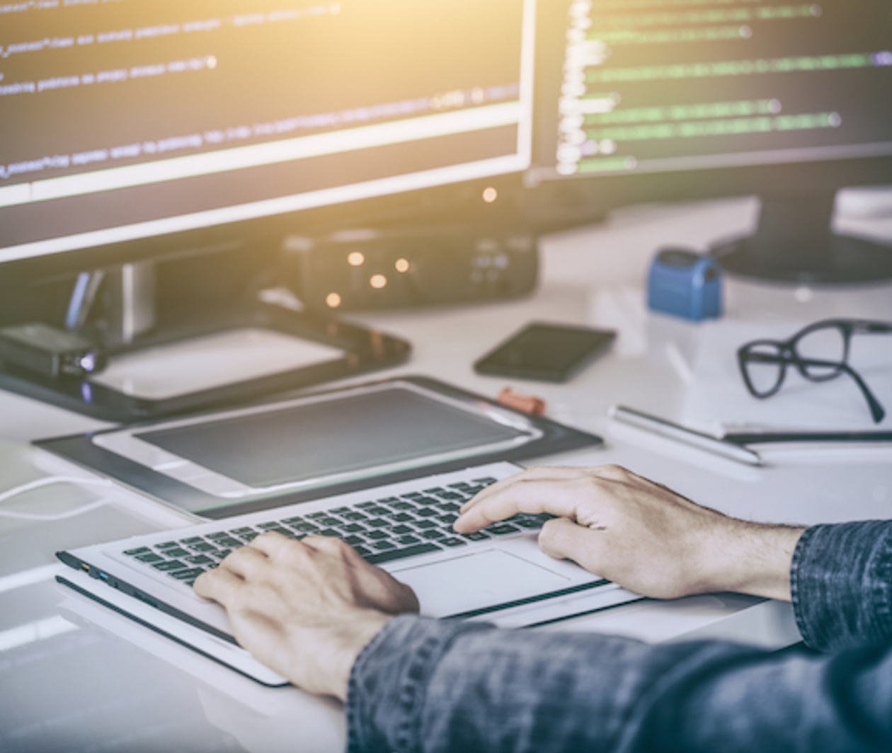 Person working at a computer writing computer code