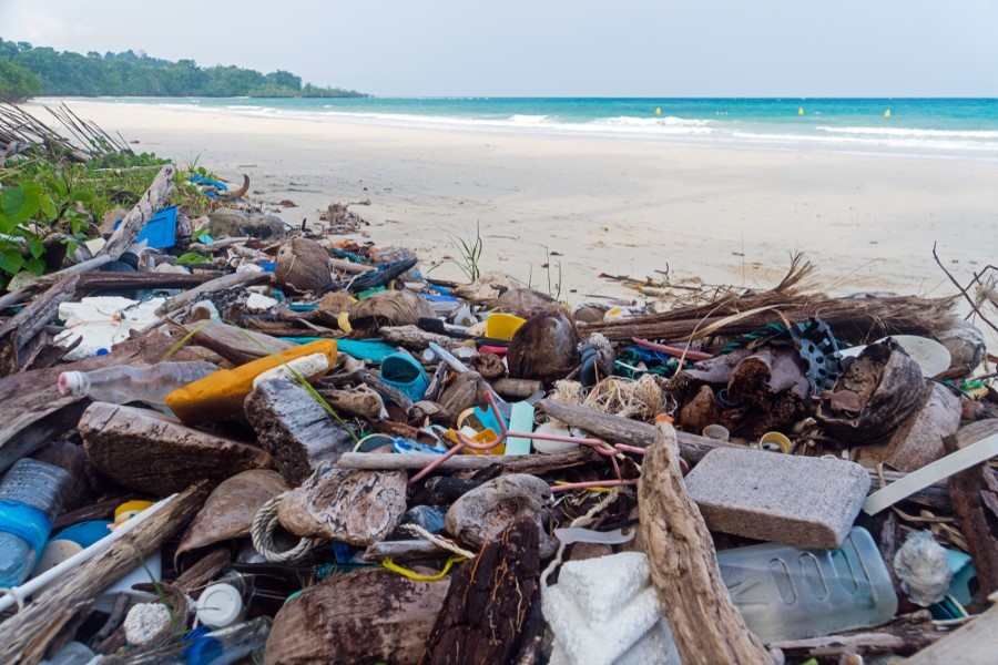 Plastic garbage and other waste on a beautiful tropical beach