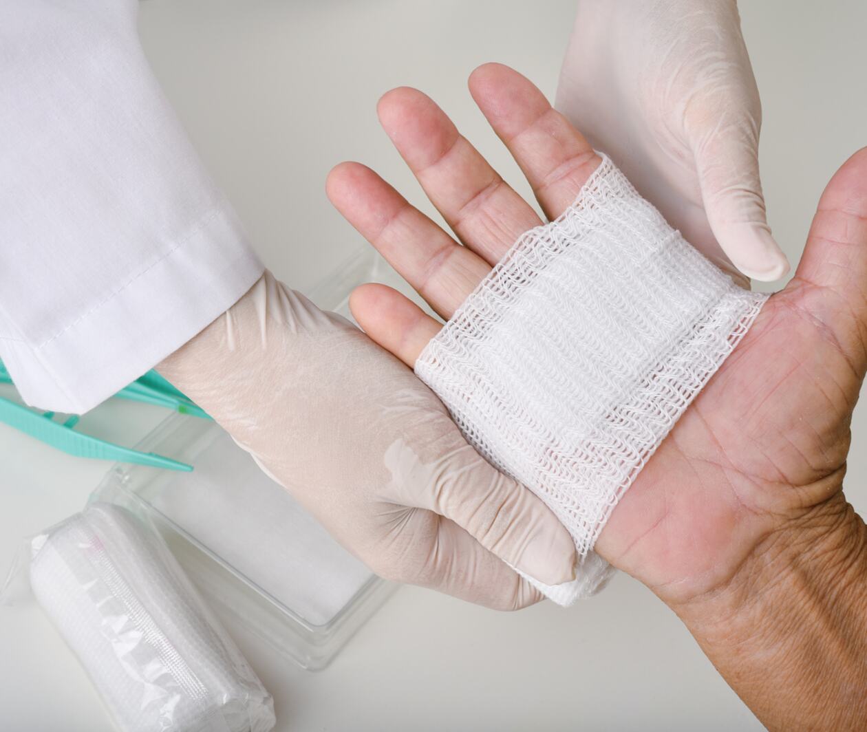 Doctor bandaging a hand