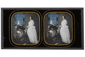 Stereo ambrotype, glass, depicting two unidentified women, one seated and one standing, the latter holding a plant on a plinth, by Charles F. Ravis, Bristol, 1857 – 1859/ IL.2003.44.1.162 © Howarth-Loomes Collection at National Museums Scotland