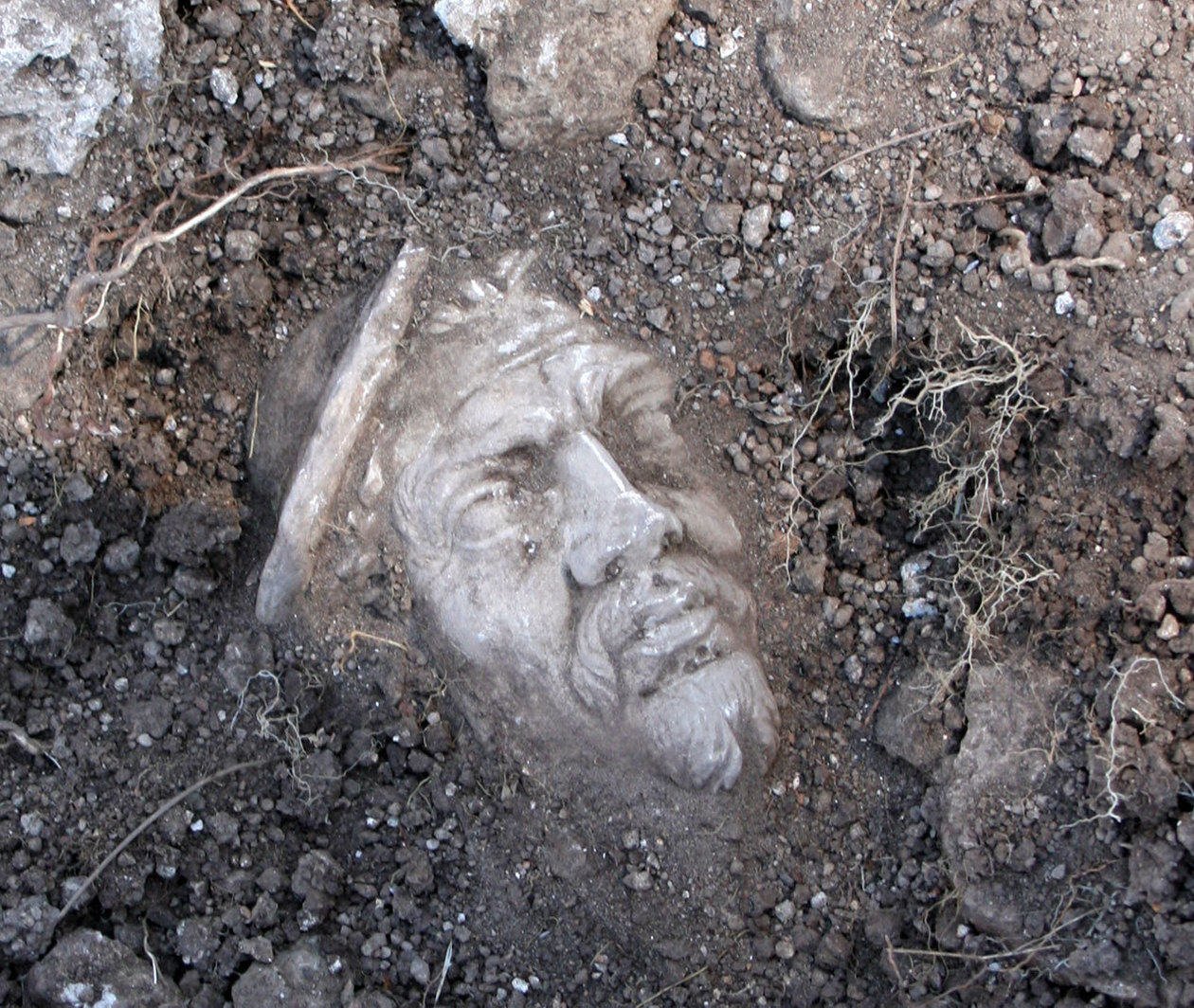 A marble head revealed in the earth as an archaeological find at Portus