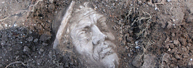 A marble head revealed in the earth as an archaeological find at Portus