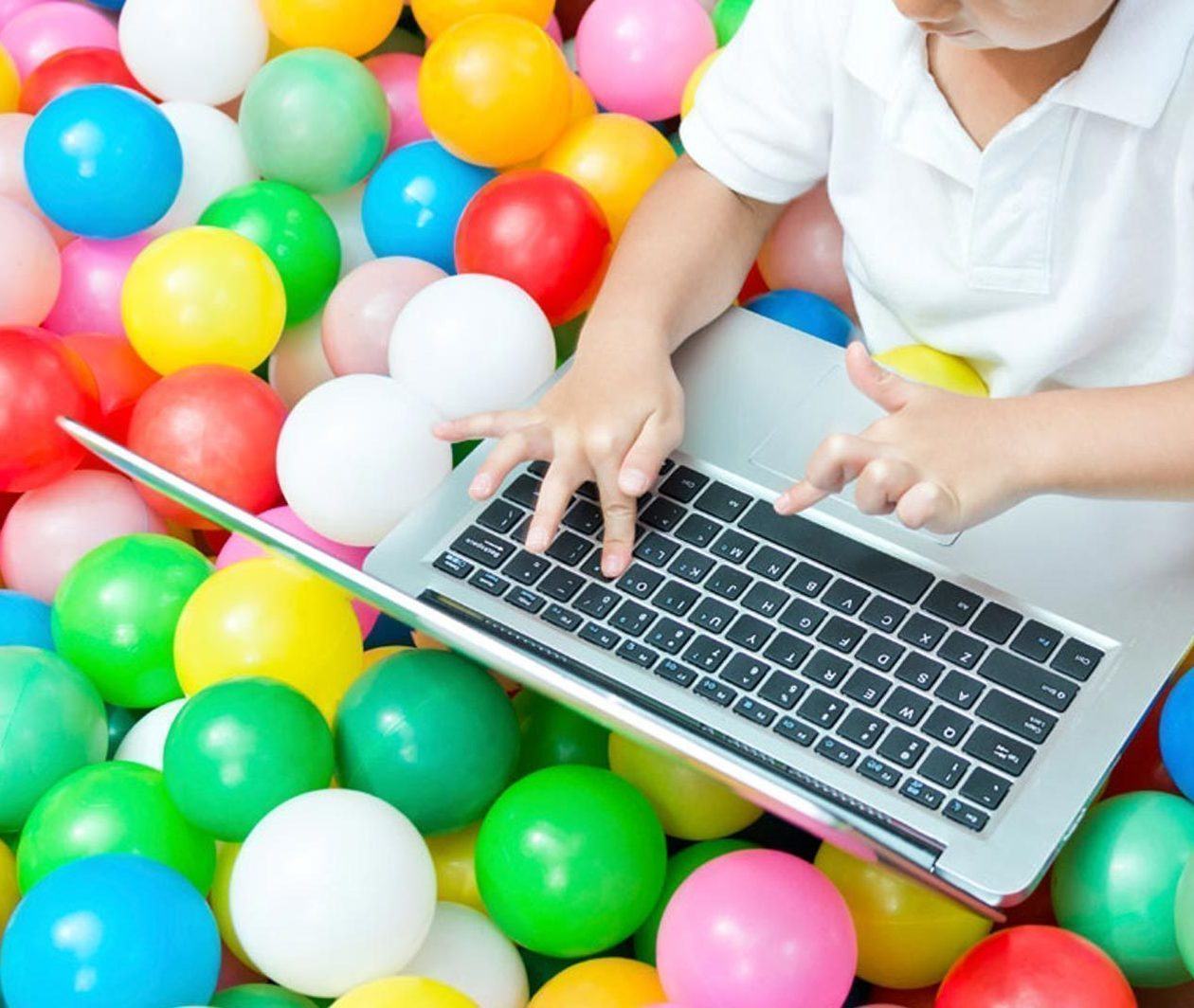 Childhood in the Digital Age - a child using a laptop