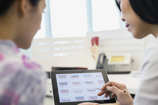 Doctor and patient reviewing data on a digital tablet