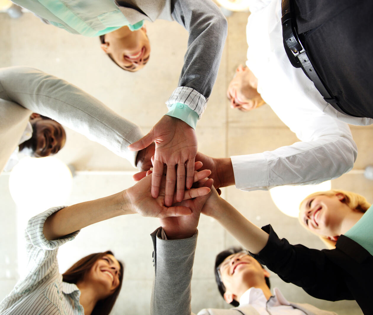 Group of professionals doing a group high-five