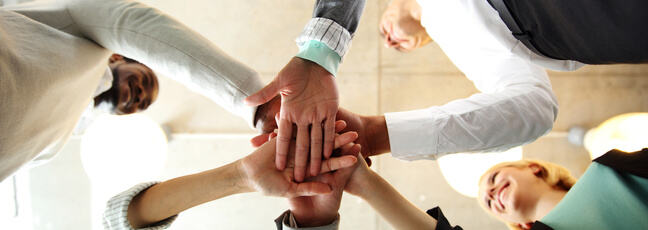 Group of professionals doing a group high-five