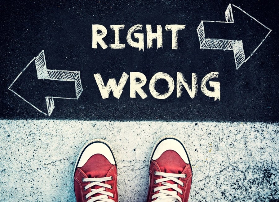 birdseye view photo of red trainers standing in front of an arrow for wrong on the left and right on the right