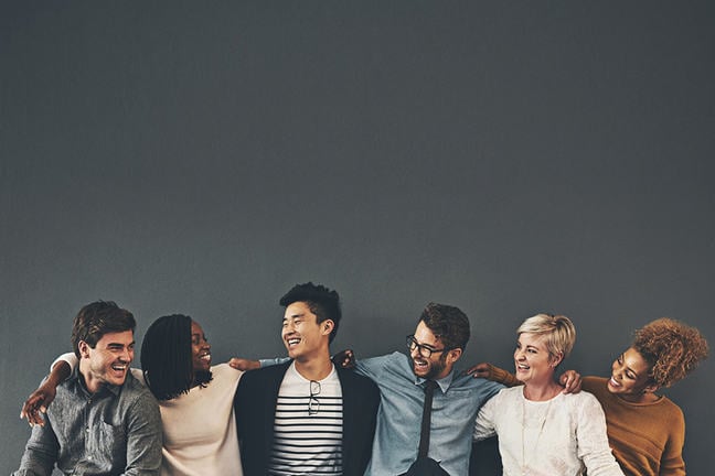 We make a great team Studio shot of a diverse group of creative employees embracing each other against a grey background