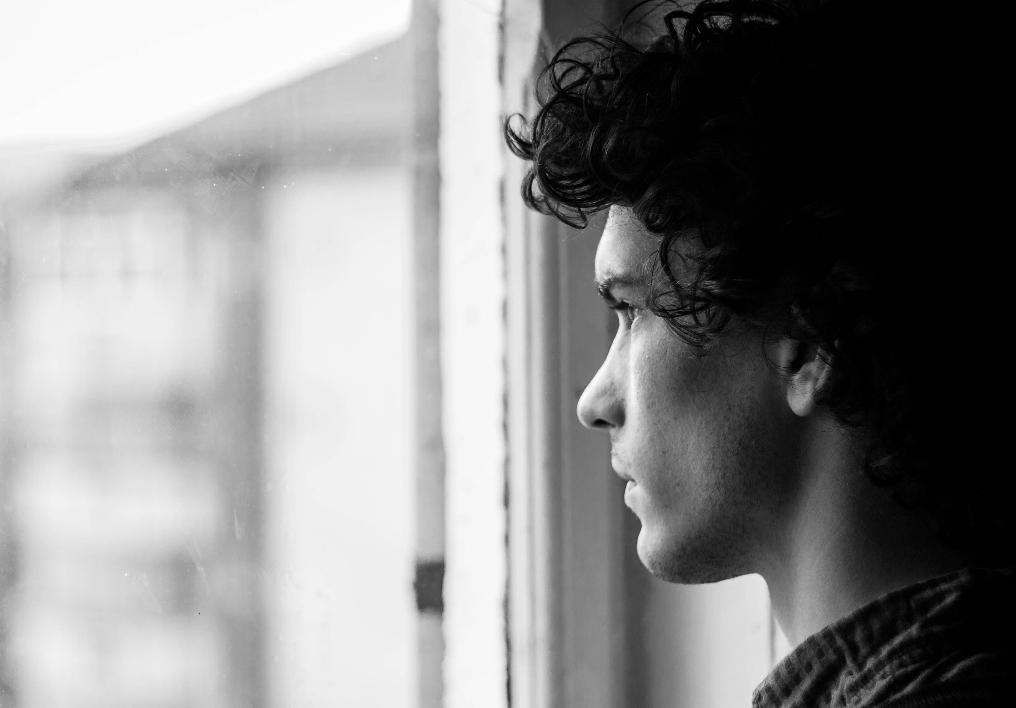 A man looking out of a window.