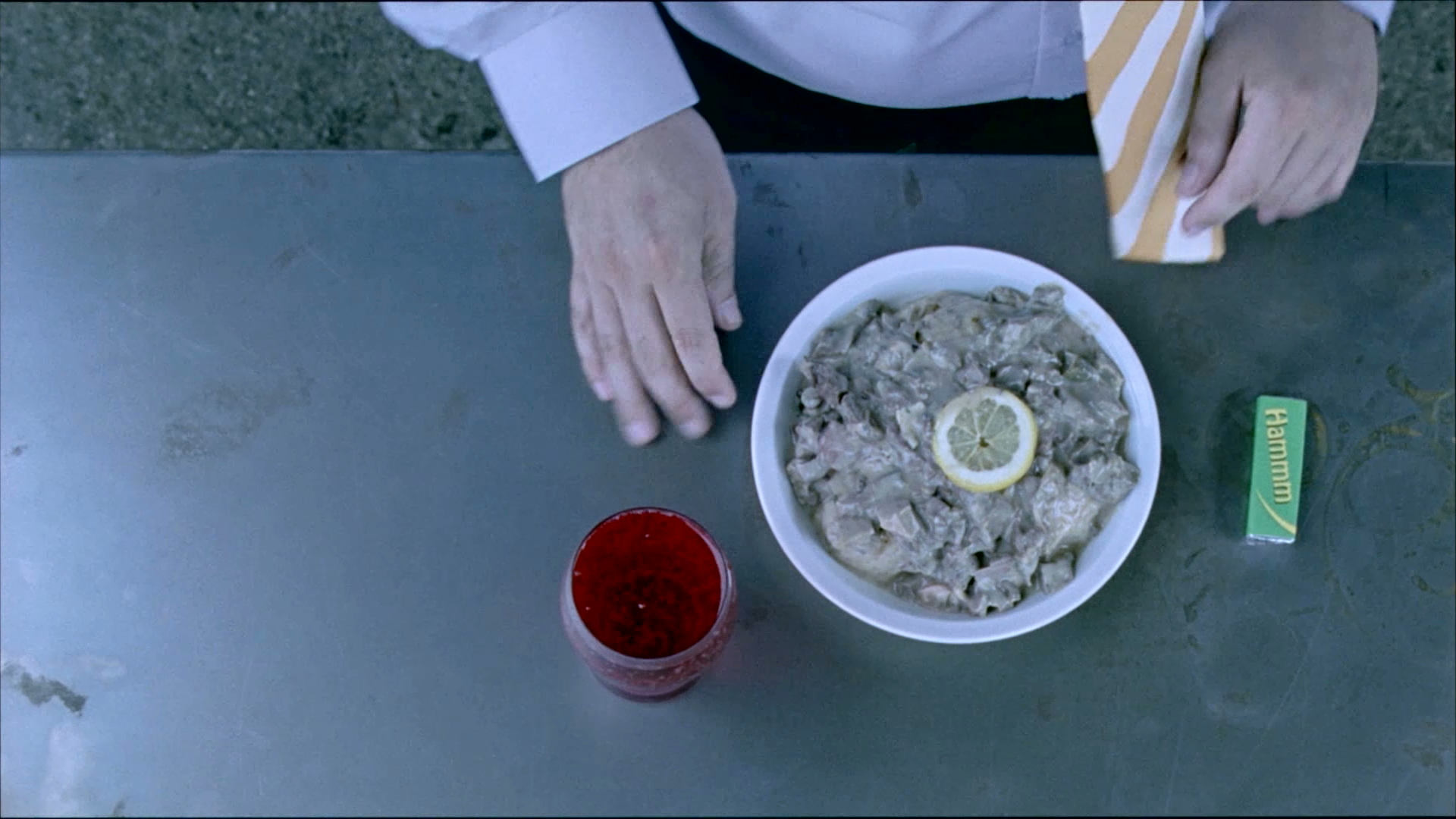 Birds eye view close up shot of a man eating at a cafe from the film Szalontudo