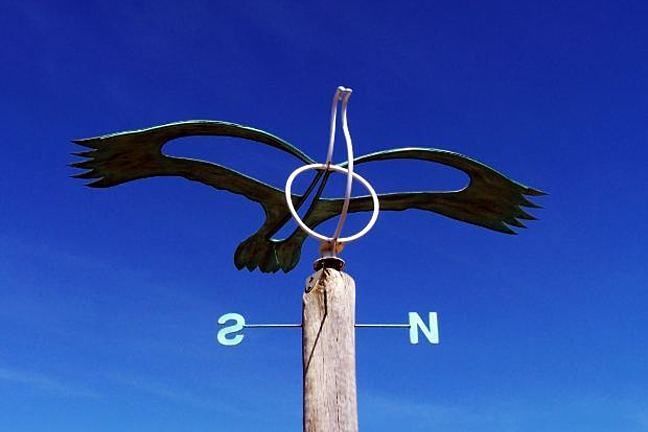 Weather vane with North and South directions visible