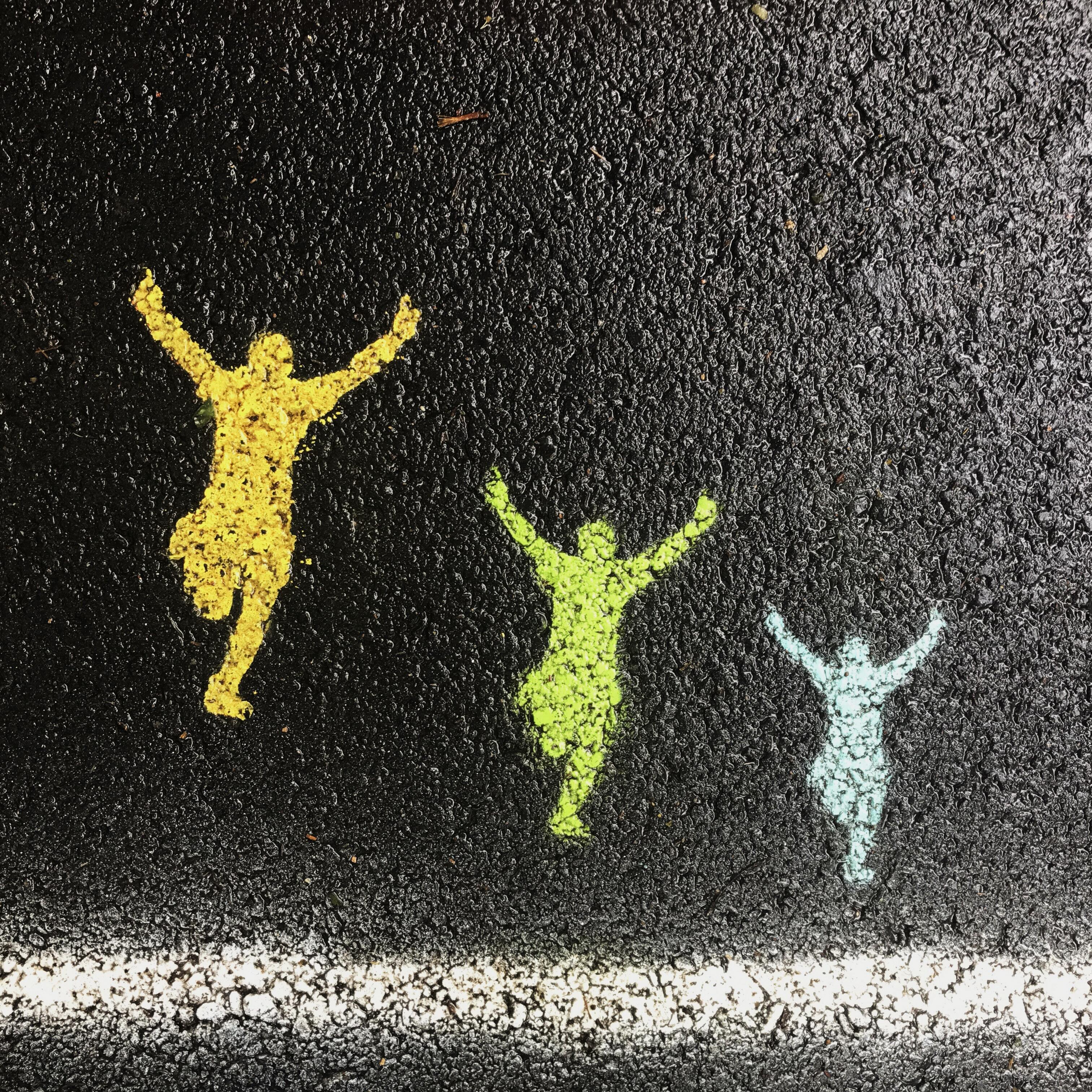 chalk drawings of people jumping